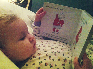 Very young child enjoying the Red is Best board book